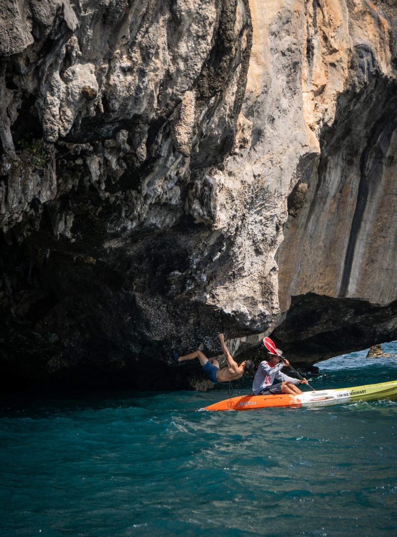 Kayak dropping off climber